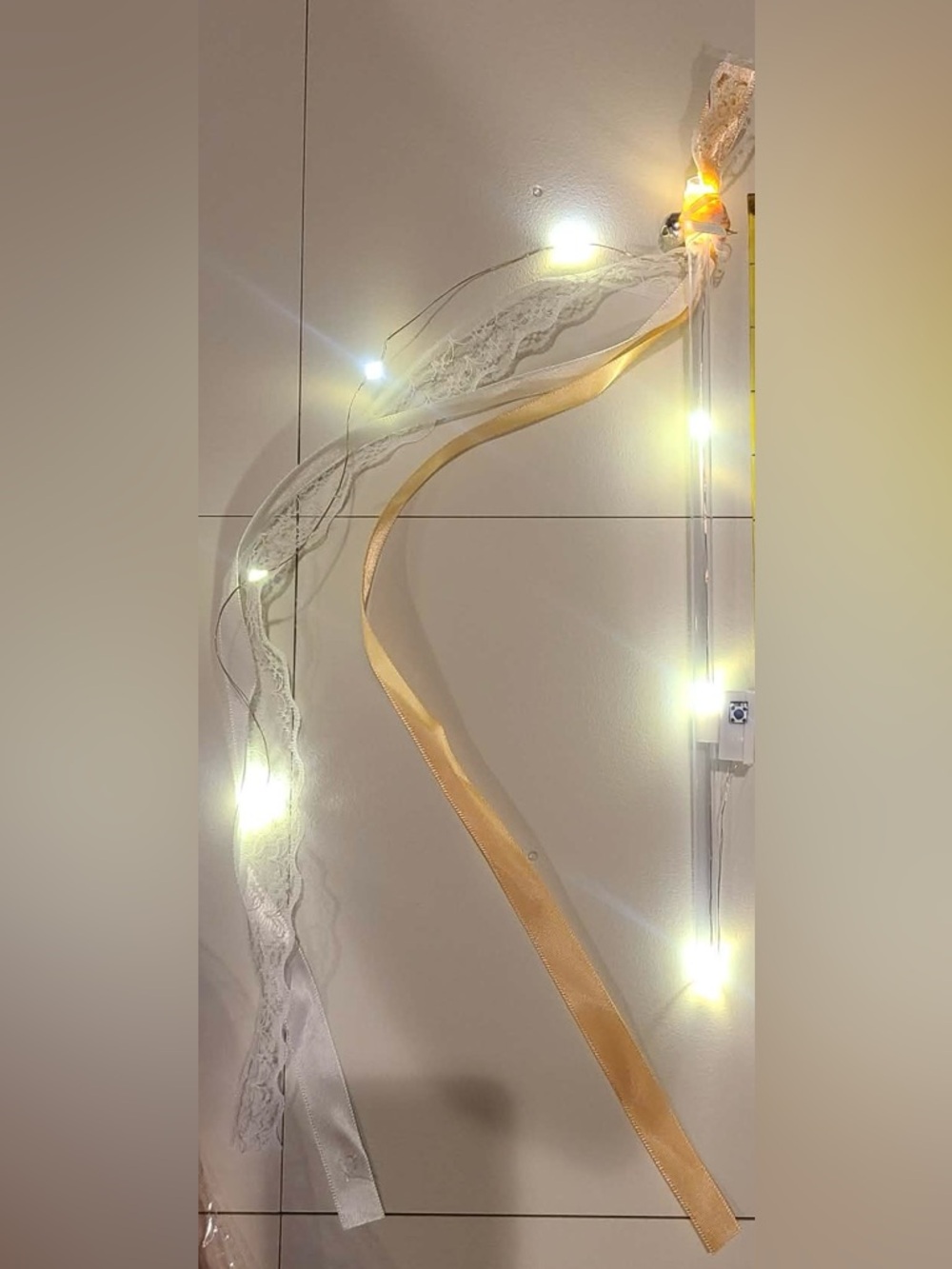 50 individually wrapped LED wands with Champagne ribbon and white lace with bell